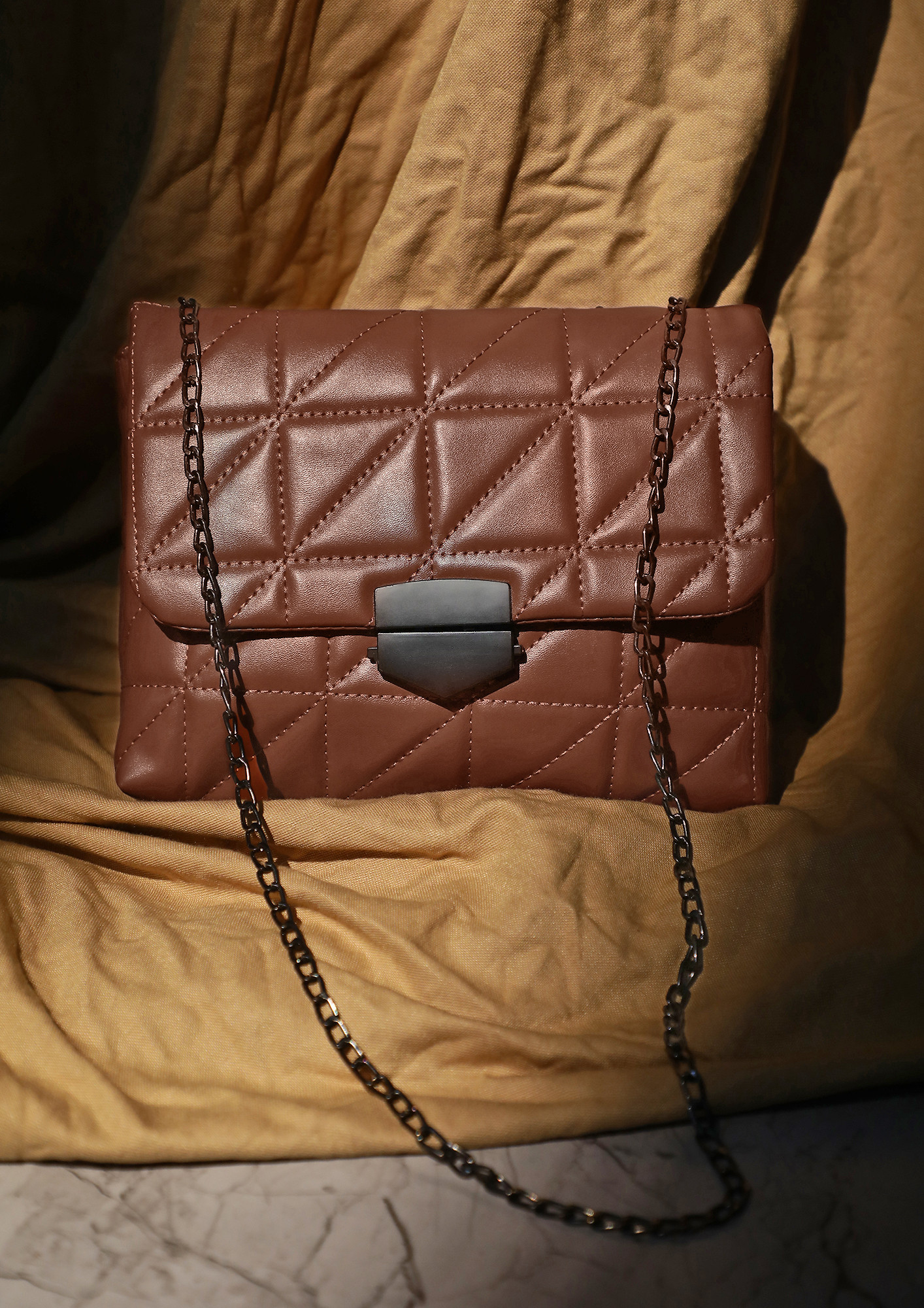 CHAINS AND CHIMES CARAMEL SLING BAG